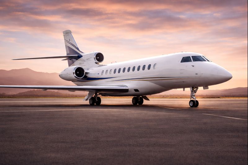 Falcon 7X private jet at sunset on tarmac